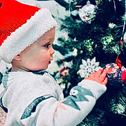 Jackson joined the competition — help win amazing prizes! adult, baby, cap, christmas, christmasdecorations, christmastree, christmastreeornaments, clothing, face, festival, hat, head, male, man, nature, openingpresent, outdoors, person, snow