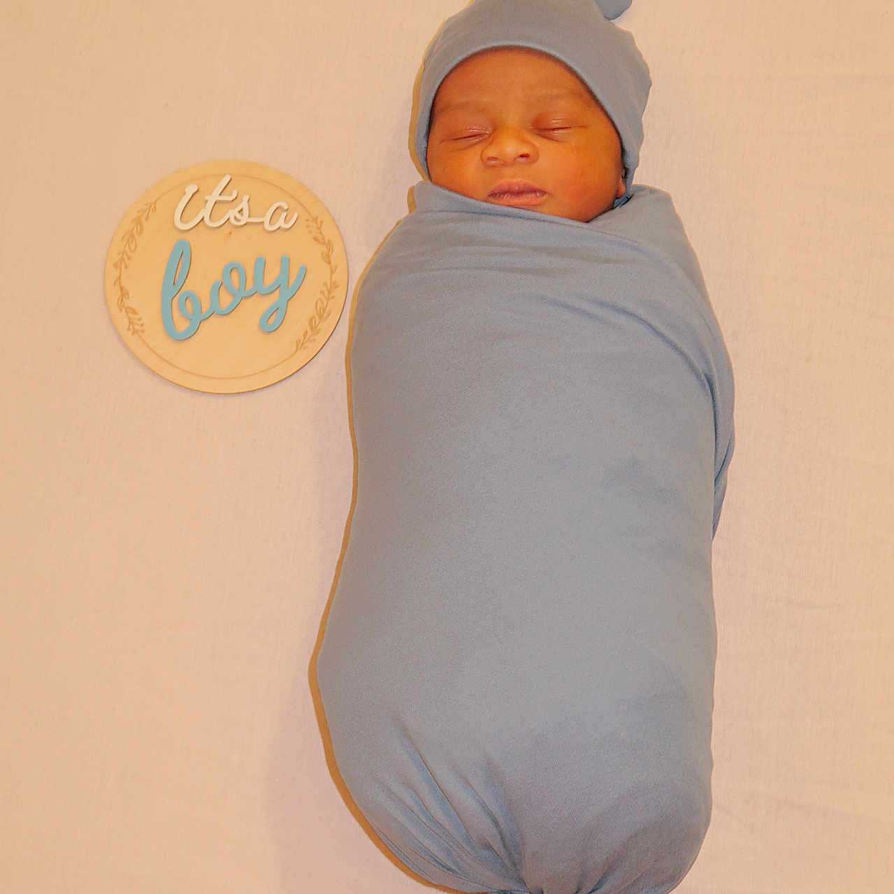 Wamala joined the competition — help win amazing prizes! announcement, baby, blue, child, cozy, cute, hat, infant, lying_down, neutral_background, newborn, peaceful, portrait, sign, sleeping, soft, swaddled, text, wooden, wrapped