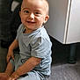 child, toddler, smile, happy, indoor, floor, clothing, shorts, tshirt, sitting, cute, baby, person, young, skin, face, eyes, hair, light, joy