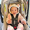 Callia joined the competition — help win amazing prizes! baby, child, car_seat, onesie, pink, white, fuzzy, hood, bear_ears, smiling, happy, infant, straps, safety, indoor, floor_tiles, cute, person, seat, clothing