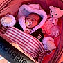 baby, sleeping, pacifier, blanket, mittens, stroller, teddy_bear, pink, cozy, child, infant, cute, warm_clothing, soft_toys, portrait, resting, indoor, bundle, headwear, comfort