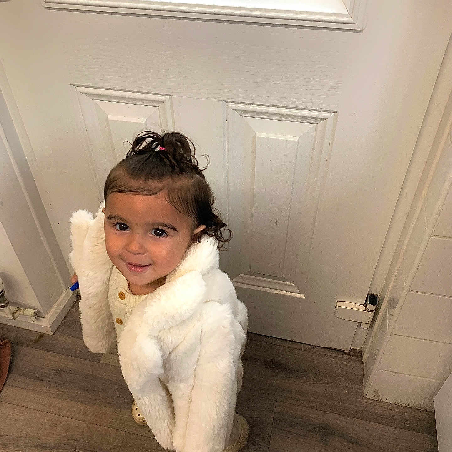 Xensia joined the competition — help win amazing prizes! child, clothing, curly_hair, cute, door, floor, hair_tie, happy, home, indoor, looking_up, person, portrait, small_child, smile, standing, toddler, white_coat, wooden_floor, young_child