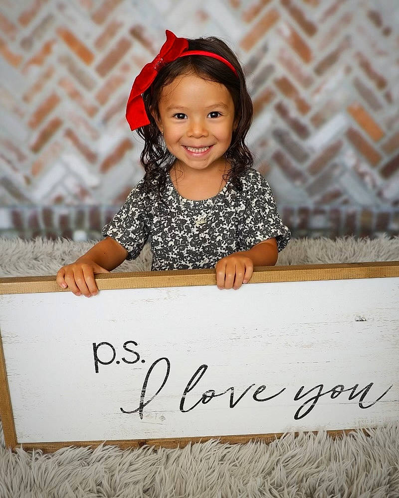 Nella joined the competition — help win amazing prizes! child, child_model, event, face, font, fun, handwriting, happy, joy, laugh, people, person, photo_caption, portrait_photography, rectangle, sitting, sleeve, smile, t_shirt, toddler