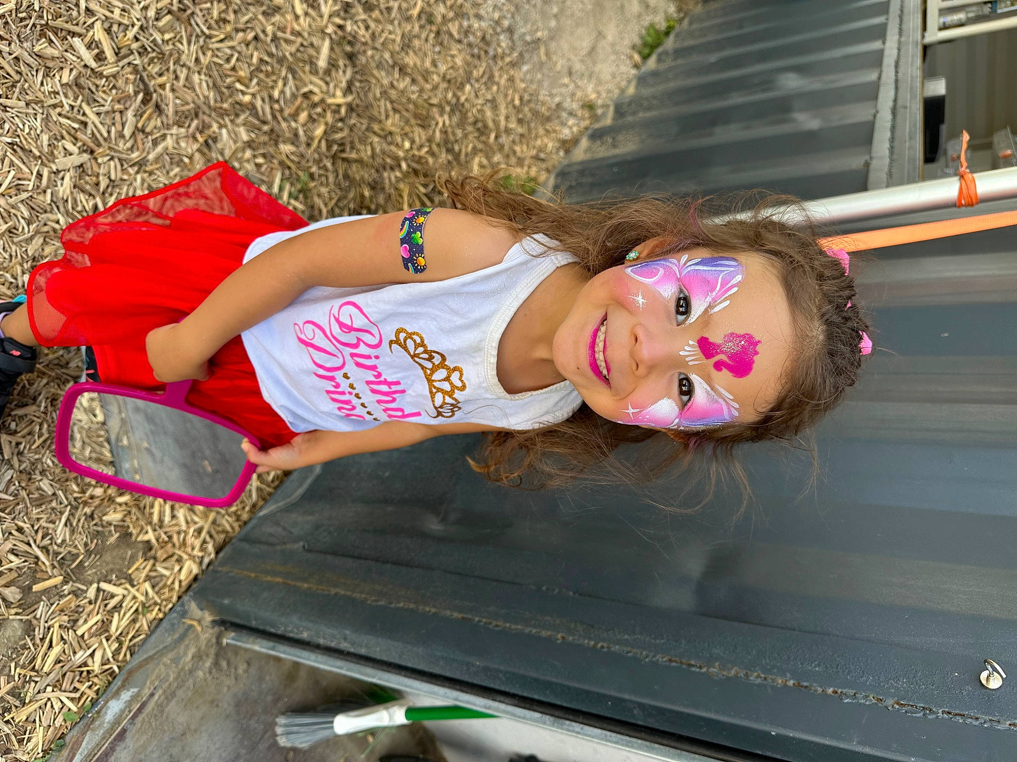 Nella is registered to the contest to win money with this photo: automotive_exterior, blond, brown_hair, bumper, chest, dress, eyewear, fashion_accessory, fun, grass, human_leg, joy, leisure, long_hair, magenta, person, pink, sandal, sunglasses, thigh