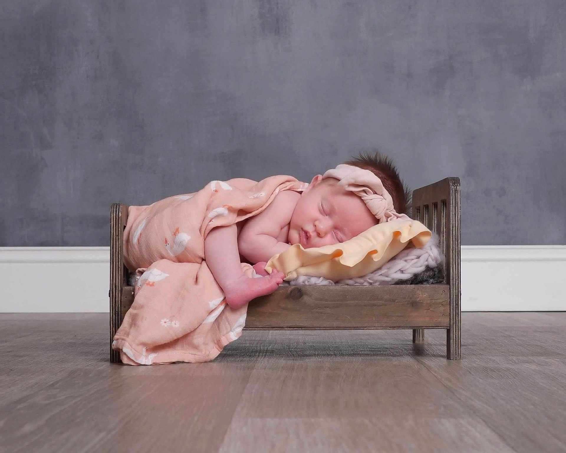 Eloise joined the competition — help win amazing prizes! baby, newborn, sleeping, blanket, headband, wooden_bed, floor, indoor, peaceful, cute, infant, portrait, soft_lighting, minimalist, cozy, pink, skin, child, rest, toddler