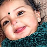 baby, bindi, blanket, child, closeup, clothing, cozy, cute, eyes, face, hair, happy, indoors, infant, mouth, nose, person, portrait, skin, smile