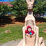 James is registered to the contest to win money with this photo: blue_ball, child, daylight, fun, grass, greenery, happy, kangaroo_statue, kid, nature, outdoor, park, playground, recreation, red_hoodie, sculpture, smiling, statue, sunny, tree