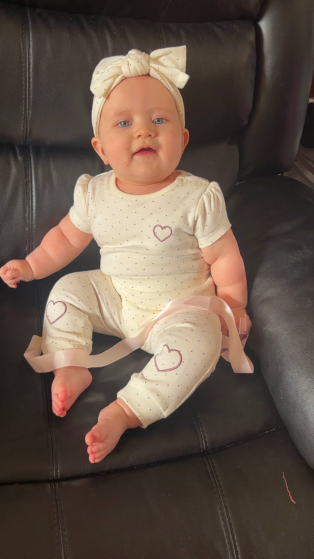 Darcie is registered to the contest to win money with this photo: baby, black, blue_eyes, bow, child, couch, cute, face, foot, hand, headband, heart, indoors, infant, leather, outfit, polka_dots, portrait, sitting, soft_lighting