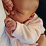 baby, newborn, sleeping, infant, onesie, pink_clothing, tiny_hand, adult_hand, manicure, close_up, portrait, indoor, blanket, lace, cuddle, peaceful, soft_texture, skin, cradle, family