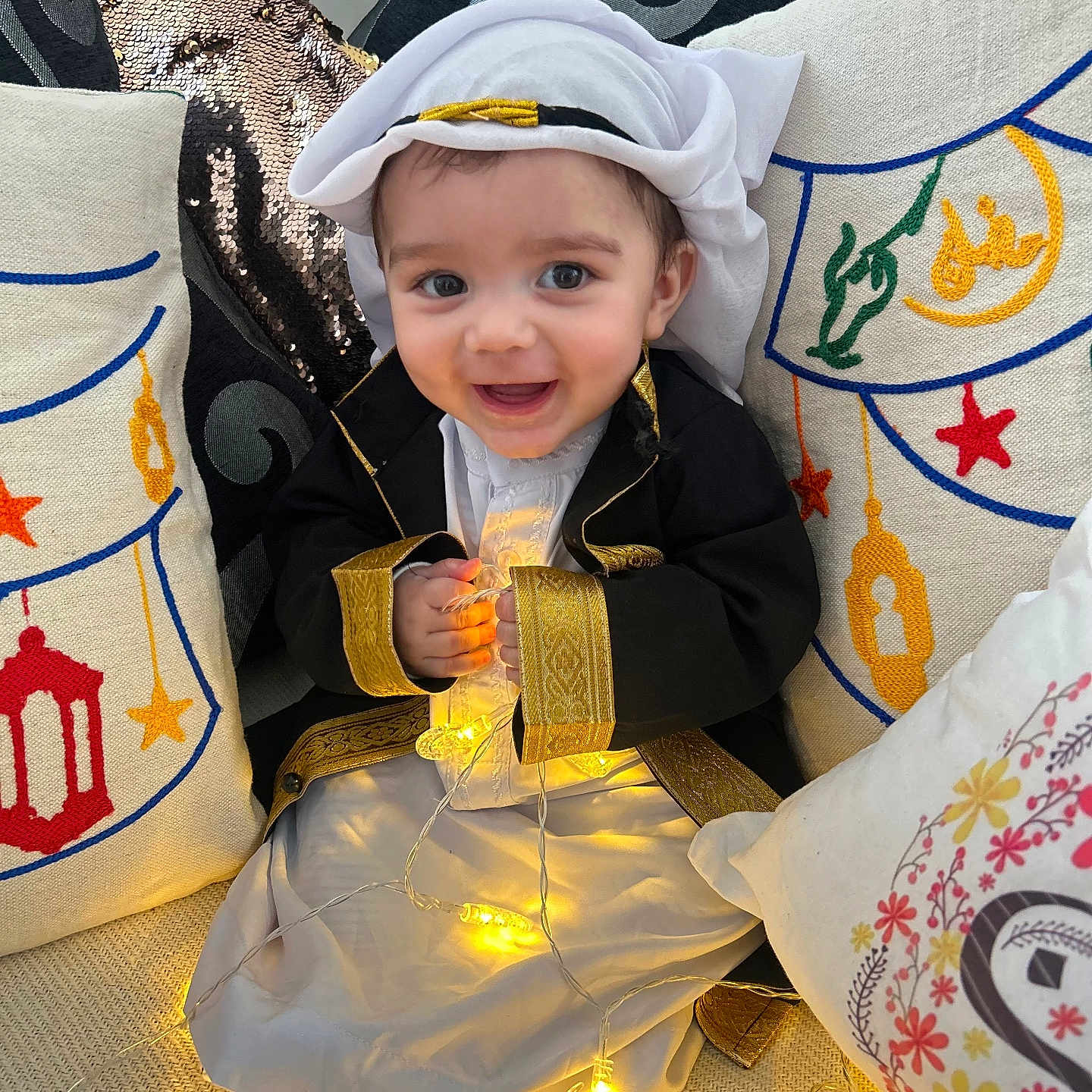 Youcef joined the competition — help win amazing prizes! baby, clothing, coat, costume, couch, cushion, dress, face, formalwear, furniture, happy, hat, head, homedecor, person, photography, pillow, portrait, sitting, smile