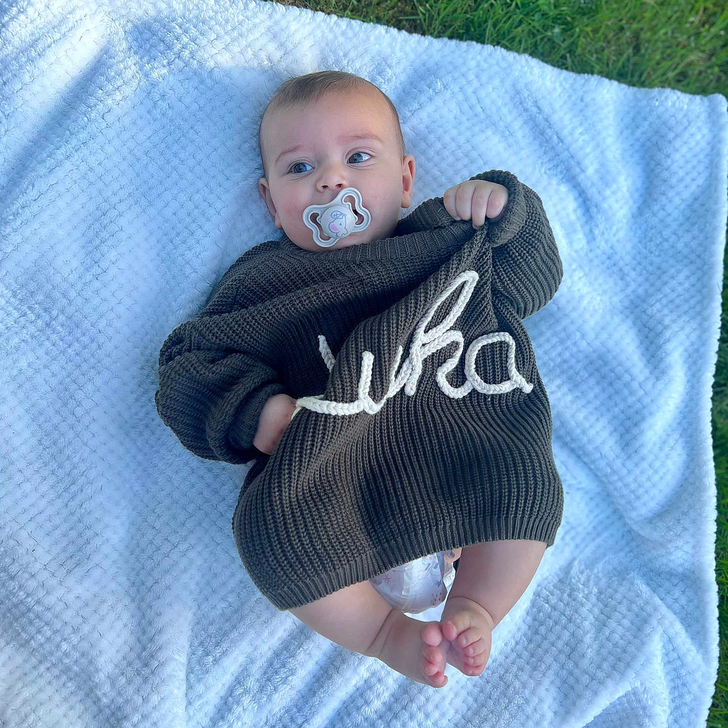 Luka joined the competition — help win amazing prizes! baby, blanket, bodypart, clothing, face, grass, hat, head, homedecor, knitwear, lawn, linen, newborn, person, photography, plant, portrait, quilt, sweater, towel