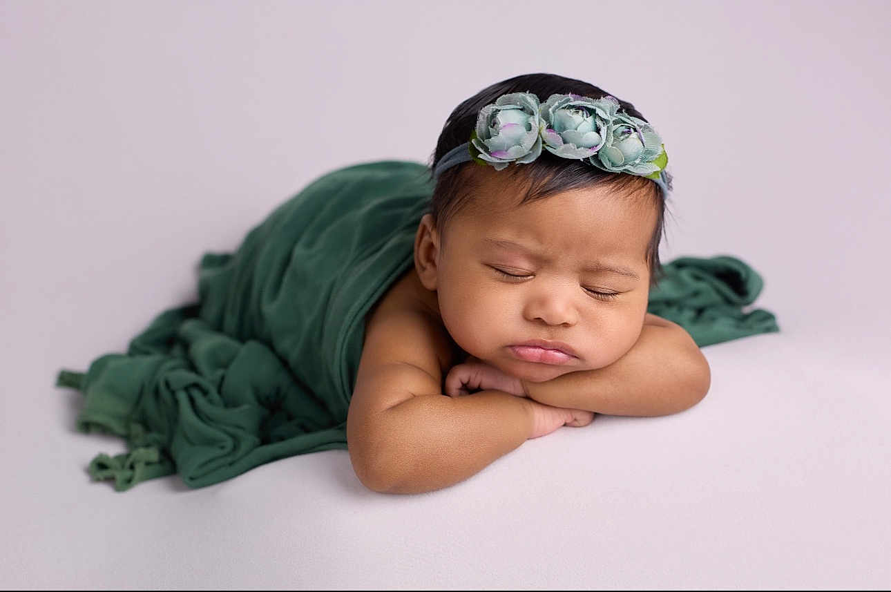 Zailani joined the competition — help win amazing prizes! baby, infant, sleeping, face, headband, flower, blanket, green, arms, resting, closeup, portrait, peaceful, soft_light, skin, cute, newborn, child, young, indoors