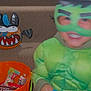 child, costume, green, mask, superhero, stairs, carpet, halloween, bucket, candy, toy, bat, decoration, smile, indoor, fun, celebration, holiday, holding, playful