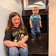 Rodney joined the competition — help win amazing prizes! child, children, stairs, indoor, smiling, happy, boy, girl, casual_clothing, denim_overalls, tshirt, sneakers, portrait, person, light, wall, floor, hair, face, pose