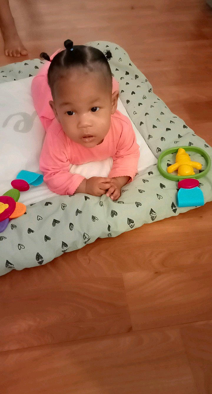 Taina participe au concours pour gagner de l'argent avec cette photo : baby, baby_toddler_clothing, cheek, child, comfort, crawling, dress, facial_expression, flooring, hairstyle, happy, head, linens, person, pink, skin, sleeve, smile, toddler, tummy_time