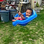 toddler, child, swing, blue, outdoor, grass, playground, backyard, toy, tricycle, rope, chair, metal_chair, plastic, garden, person, expression, daylight, casual, young_child