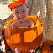 Maverick is registered to the contest to win money with this photo: autumn, baby, child, costume, cute, decorations, fall, halloween, hat, infant, leaf, natural_light, orange, outdoor, portrait, pumpkin, pumpkin_patch, seasonal, sitting, smiling