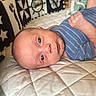 Maverick joined the competition — help win amazing prizes! newborn, baby, infant, child, portrait, lying_down, blue_outfit, striped_clothing, quilt, cushion, blanket, nursery, indoor, face, eyes, awake, hand, cozy, star_pattern, photography