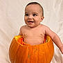 baby, pumpkin, smiling, cute, infant, orange, hollowed_pumpkin, happy, child, portrait, studio, background, skin, cheeks, eyes, tongue, sitting, bare_chest, holiday, autumn