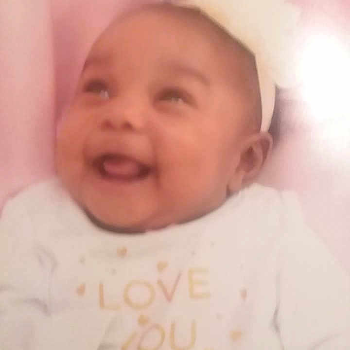 Kaydence is registered to the contest to win money with this photo: cheek, child, chin, close_up, day, eyebrow, face, facial_expression, forehead, head, human_hair_color, infant, lip, nose, person, pink, product, skin, smile, toddler