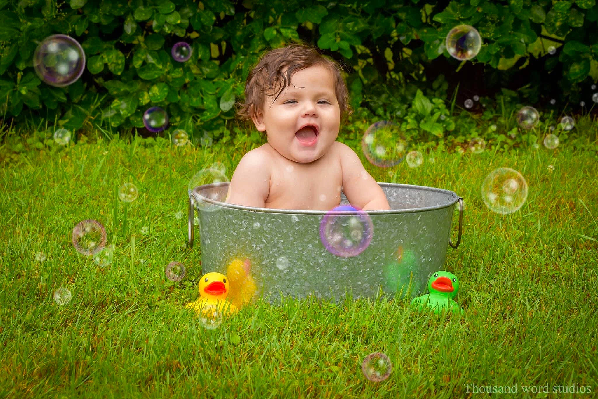 Arlan is registered to the contest to win money with this photo: baby, bathing, child, face, fun, garden, grass, grass_family, groundcover, happy, lawn, leisure, liquid_bubble, meadow, people_in_nature, person, plant, recreation, sitting, toddler