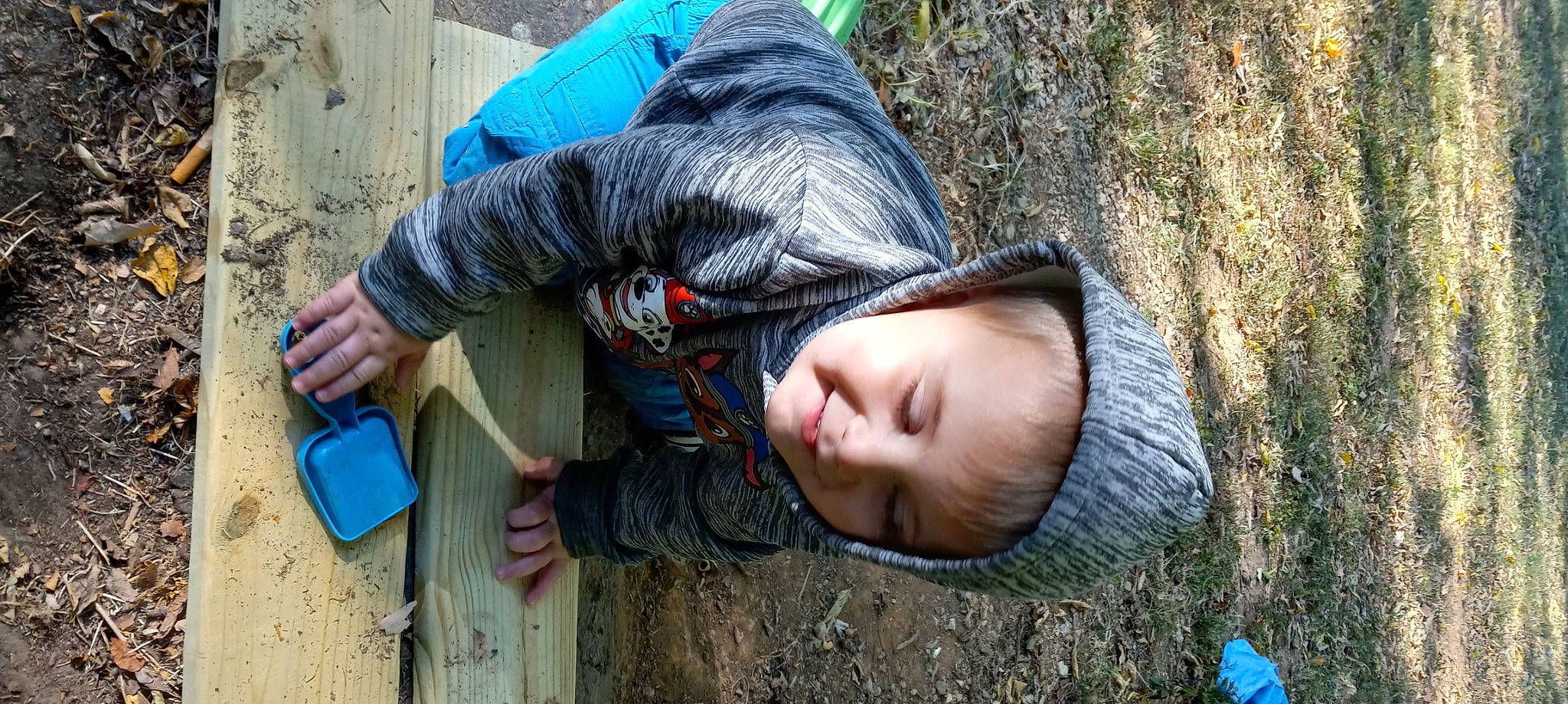 Curtis is registered to the contest to win money with this photo: adaptation, baby, blue, child, comfort, denim, fun, grass, happy, jacket, joy, landscape, leisure, people_in_nature, person, sitting, soil, toddler, tree, vacation