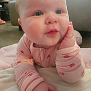 Raelynn joined the competition — help win amazing prizes! baby, infant, closeup, face, chubby_cheeks, onesie, pink_clothing, lying_on_tummy, hand_on_face, blue_eyes, pout, blanket, couch, floor, indoor, portrait, soft_lighting, cute, baby_hands, home