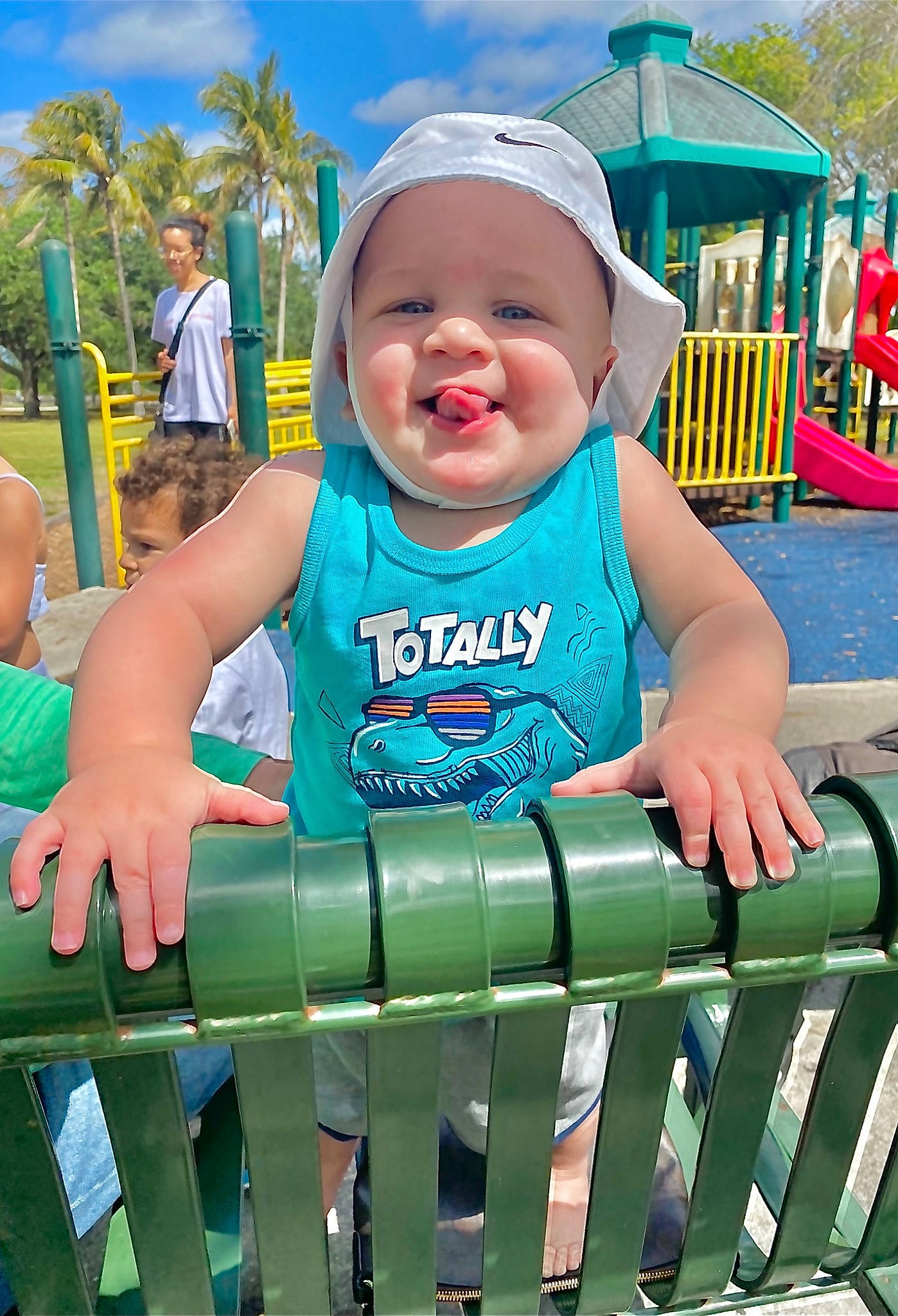 Damien is registered to the contest to win money with this photo: baby, baby_toddler_clothing, blue, child, cloud, fun, grass, green, happy, headwear, leisure, person, photograph, playground, recreation, shorts, sky, sleeve, smile, summer