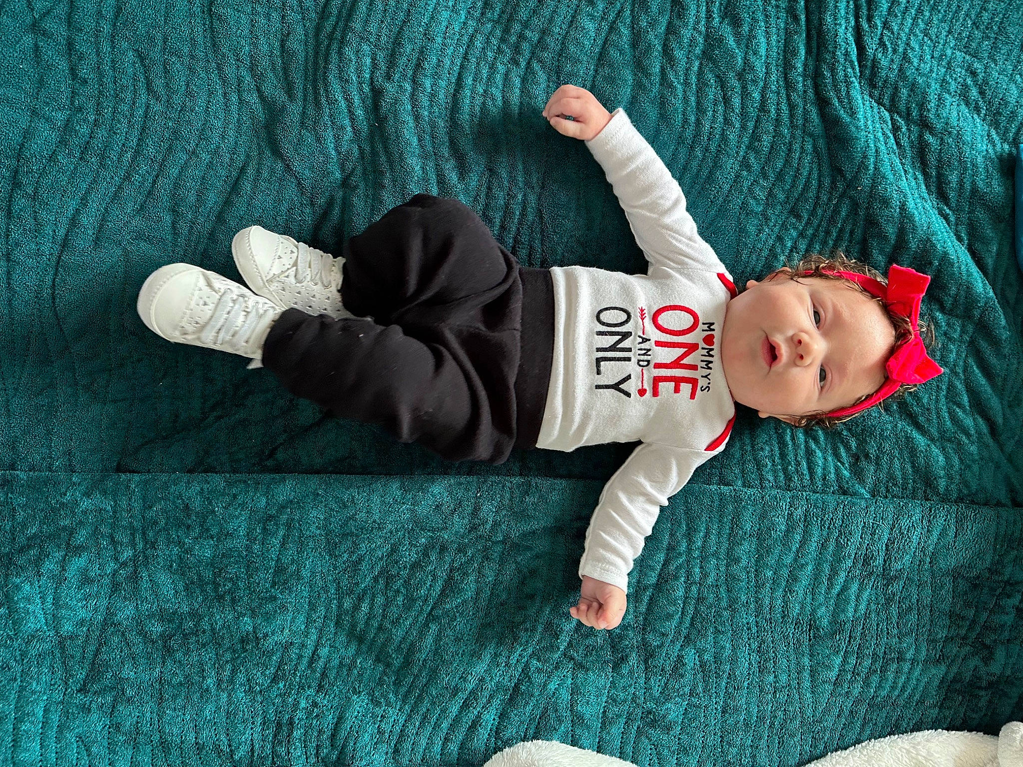 Khelani joined the competition — help win amazing prizes! arm, baby, baby_toddler_clothing, comfort, finger, foot, gesture, grass, hand, hat, head, human_body, leg, linens, pattern, person, sitting, skin, sleeve, sock