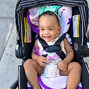 Mieah joined the competition — help win amazing prizes! baby, smile, stroller, child, infant, harness, blanket, headband, outdoor, cute, happy, seat, clothing, person, legs, barefoot, purple, black, safety, portrait