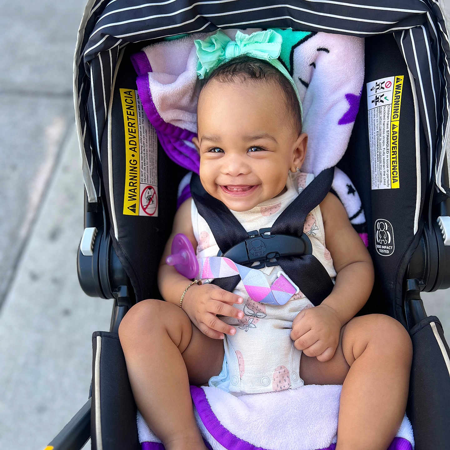 Mieah joined the competition — help win amazing prizes! baby, barefoot, black, blanket, child, clothing, cute, happy, harness, headband, infant, legs, outdoor, person, portrait, purple, safety, seat, smile, stroller