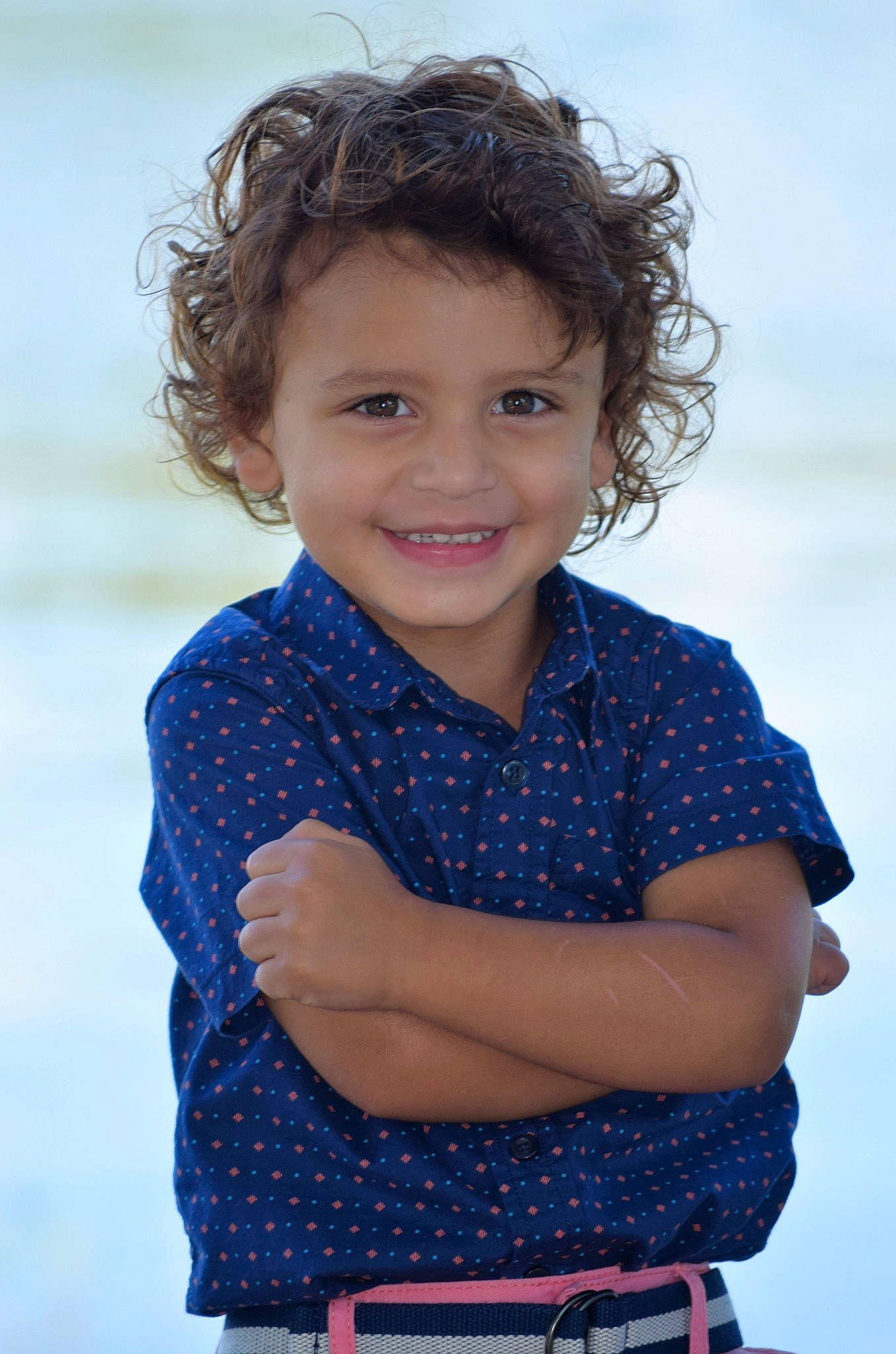 Alijah is registered to the contest to win money with this photo: arm, blue, brown_hair, child, child_model, chin, face, facial_expression, gesture, hair, hairstyle, happy, joy, neck, pattern, person, photography, portrait_photography, sleeve, smile
