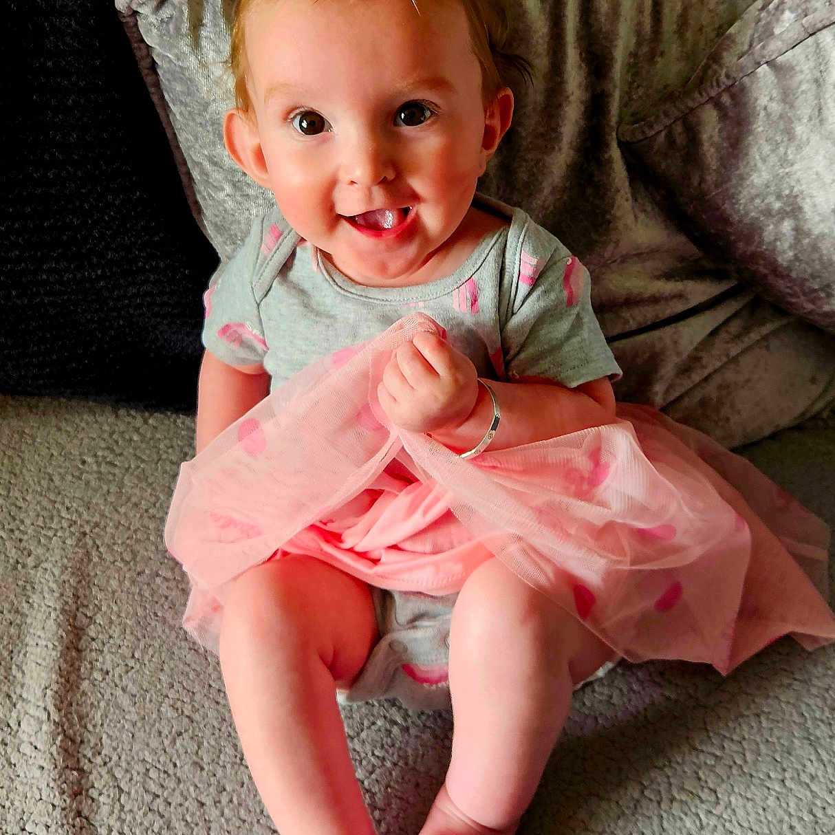 Danielle is registered to the contest to win money with this photo: baby, bodypart, chair, clothing, couch, cushion, dress, face, finger, furniture, happy, head, heart, homedecor, person, photography, portrait, sitting, smile, symbol