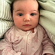 Olivia joined the competition — help win amazing prizes! baby, infant, face, eyes, clothing, blanket, bed, soft, cute, portrait, newborn, skin, hand, sleepwear, fabric, closeup, child, person, expression, cozy