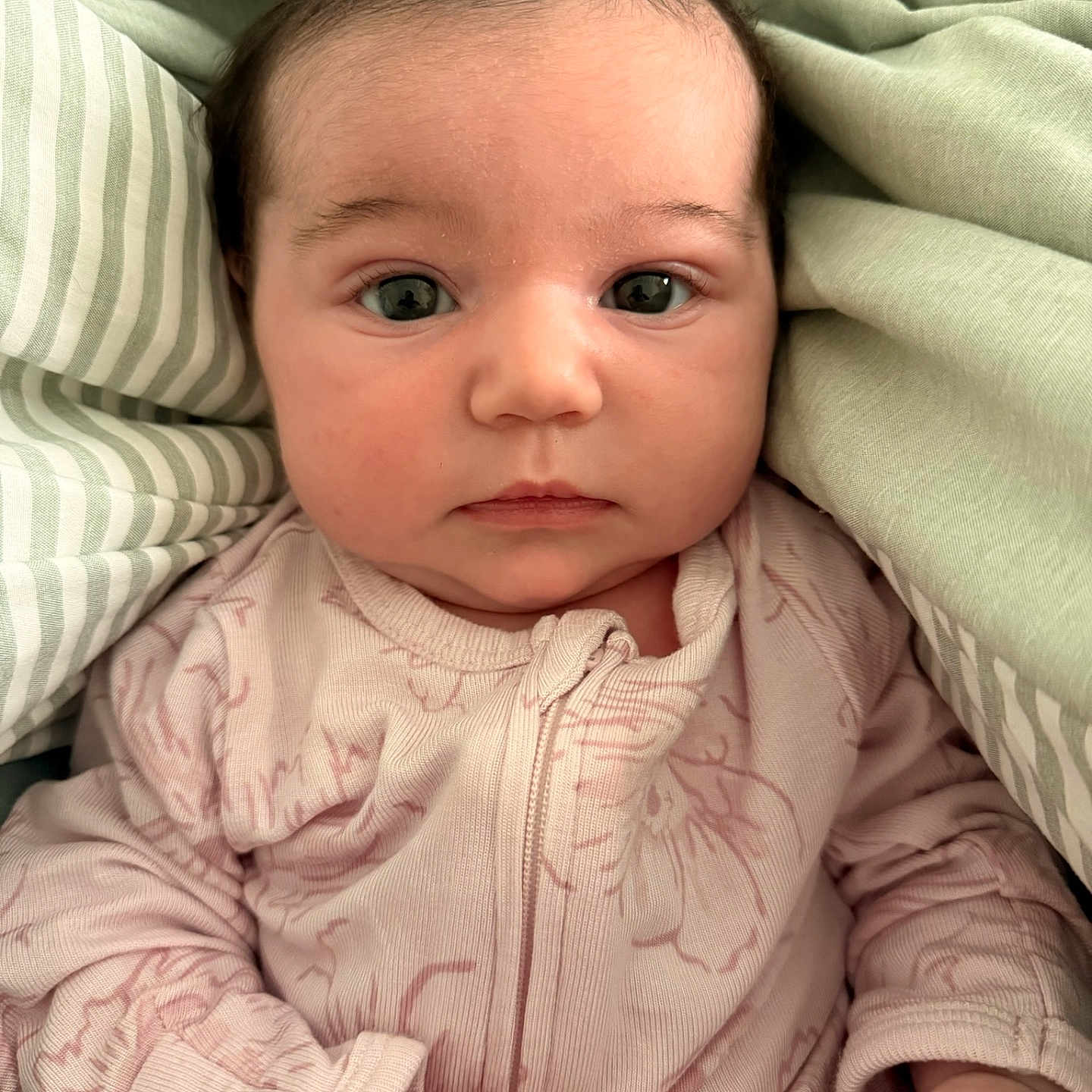 Olivia joined the competition — help win amazing prizes! baby, infant, face, eyes, clothing, blanket, bed, soft, cute, portrait, newborn, skin, hand, sleepwear, fabric, closeup, child, person, expression, cozy
