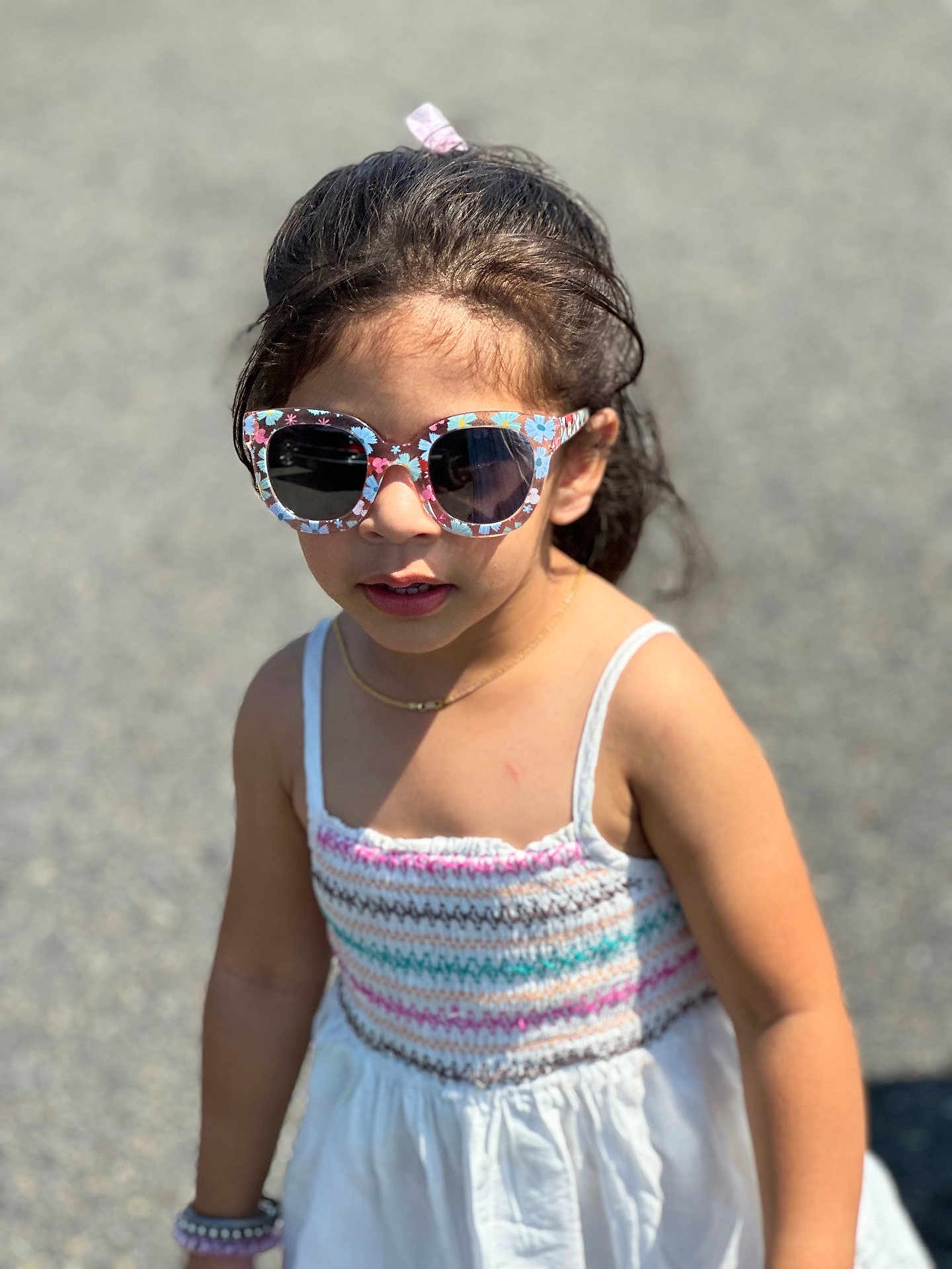 Sahib is registered to the contest to win money with this photo: child, girl, sunglasses, outdoor, sunlight, dress, colorful, knit, bracelet, hair, person, summer, fashion, accessories, young, cute, casual, portrait, standing, daylight