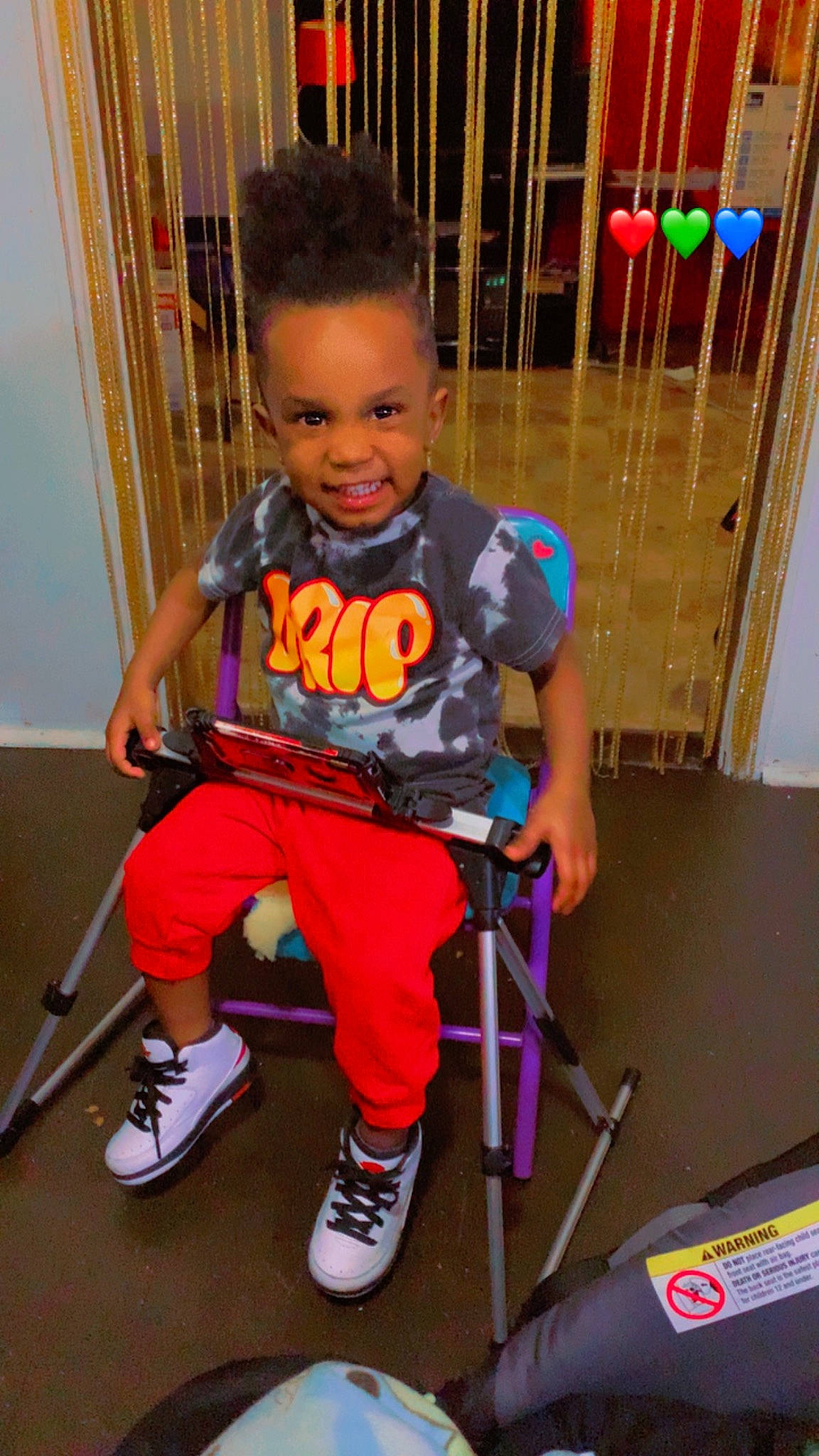 Emon Rockett joined the competition — help win amazing prizes! boot, chair, child, clothing, electric_blue, fun, joy, knee, leg, outdoor_shoe, person, play, sandal, shoe, shorts, smile, sneakers, standing, t_shirt, thigh