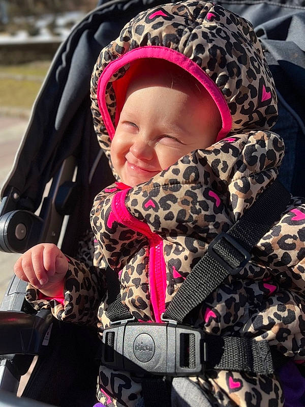 Veronica is registered to the contest to win money with this photo: baby, baby_carriage, baby_products, baby_toddler_clothing, cap, child, cool, facial_expression, fashion_accessory, fun, happy, joy, magenta, pattern, person, personal_protective_equipment, photograph, pink, smile, snapshot