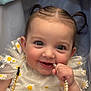 adorable, baby, child, closeup, cute, daisy_pattern, dress, fabric, face, hand, happy, infant, pearl_necklace, person, pigtails, playful, portrait, smile, soft_lighting, young