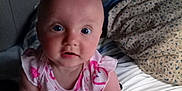 Aero joined the competition — help win amazing prizes! arms, baby, bed, blanket, child, clothing, cute, expression, face, indoors, infant, looking, mouth_open, pattern, person, pillow, pink, sitting, skin, young