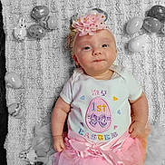 Aero is registered to the contest to win money with this photo: baby, infant, easter, pink, tutu, headband, flower, onesie, eggs, bunny, knitted_blanket, holiday, celebration, cute, portrait, lying_down, decorations, child, smiling, festive