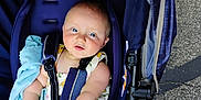 Aero joined the competition — help win amazing prizes! baby, blue_eyes, stroller, blanket, child, infant, seatbelt, outdoor, pavement, footwear, legs, summer_clothing, cute, person, baby_girl, sitting, soft_toy, candid, daylight, comfort