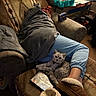 Seamus is registered to the contest to win money with this photo: blanket, carpet, cat, couch, cozy, curious_cat, footwear, furniture, home, indoor, legs, patterned_fabric, pens, person, relaxing, resting, sitting, slippers, stationery, table