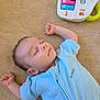 baby, infant, sleeping, face, onesie, blue_onesie, arm, hand, carpet, toy, musical_toy, xylophone, lying_down, nap, peaceful, newborn, hair, skin, cute, indoor