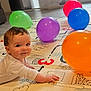 baby, child, balloons, play_mat, indoor, curtains, floor, colorful, smiling, person, portrait, crawling, toddler, home, daylight, window, curly_hair, happy, toy, playtime