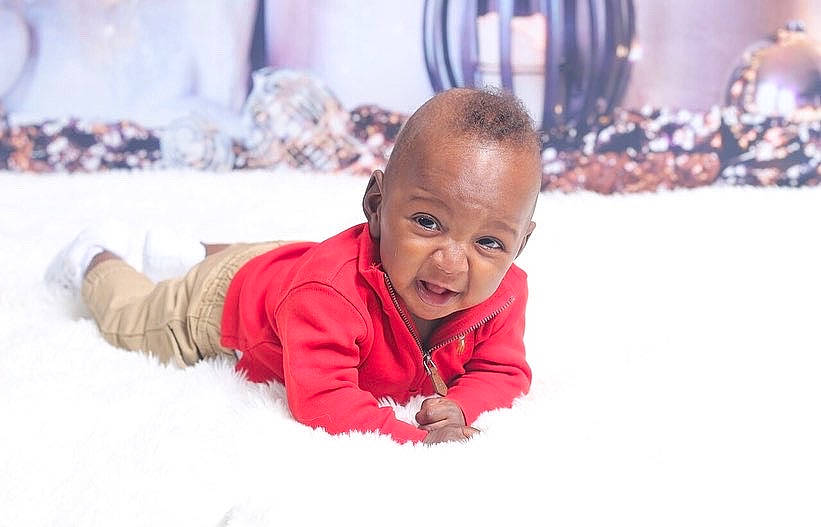 Braylin joined the competition — help win amazing prizes! baby, child, crawling, event, flooring, freezing, fun, fur, happy, leisure, person, play, playing_in_the_snow, portrait_photography, recreation, sitting, smile, snow, toddler, tummy_time