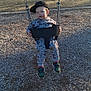 Bryson joined the competition — help win amazing prizes! baby_swing, cap, casual, child, clothing, daylight, fun, grass, hat, house, outdoor, park, person, playground, playing, shoes, sunlight, swing, trees, wood_chips