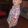 barefoot, boy, carpet, celebration, child, crown, cute, furniture, happy, headwear, indoor, person, plaid_shirt, room, shorts, smiling, standing, television, toddler, toys