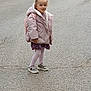 child, girl, standing, pavement, jacket, backpack, tights, dress, sneakers, ponytail, hair_tie, outdoor, smiling, person, road, casual_clothing, fashion, cute, young, confident