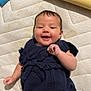 baby, smiling, infant, navy_blue_clothing, mattress, lying_down, cute, happy, child, young_child, indoor, portrait, person, face, skin, hand, head, short_hair, casual_clothing, playful